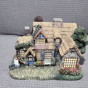 Charming Cottage Figurine with Floral Details